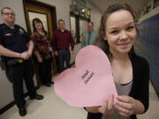 Heidi Stewart, 18, a senior student at Evergreen High School, holds a paper heart with her name printed on it. She collapsed at school in February after suffering sudden cardiac arrest. Helping her that day, from left to right, are Eric McCaleb, Dianna Lynch, Reuben Dohrendorf and Marshall Pendleton.