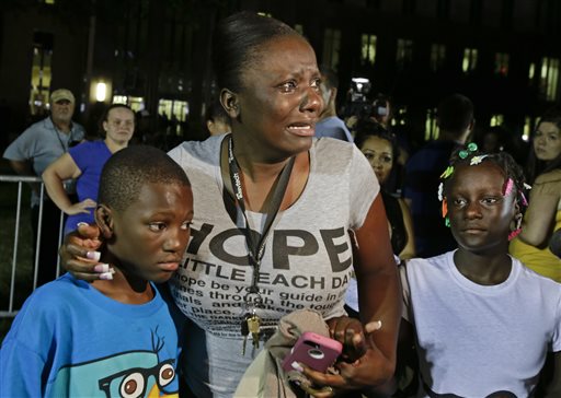 Darrsie Jackson, center, reacts after hearing the verdict of not guilty in the trial of George Zimmerman with her children Linzey Stafford, left, 10, and Shauntina Stafford, 11, at the Seminole County, Fla.