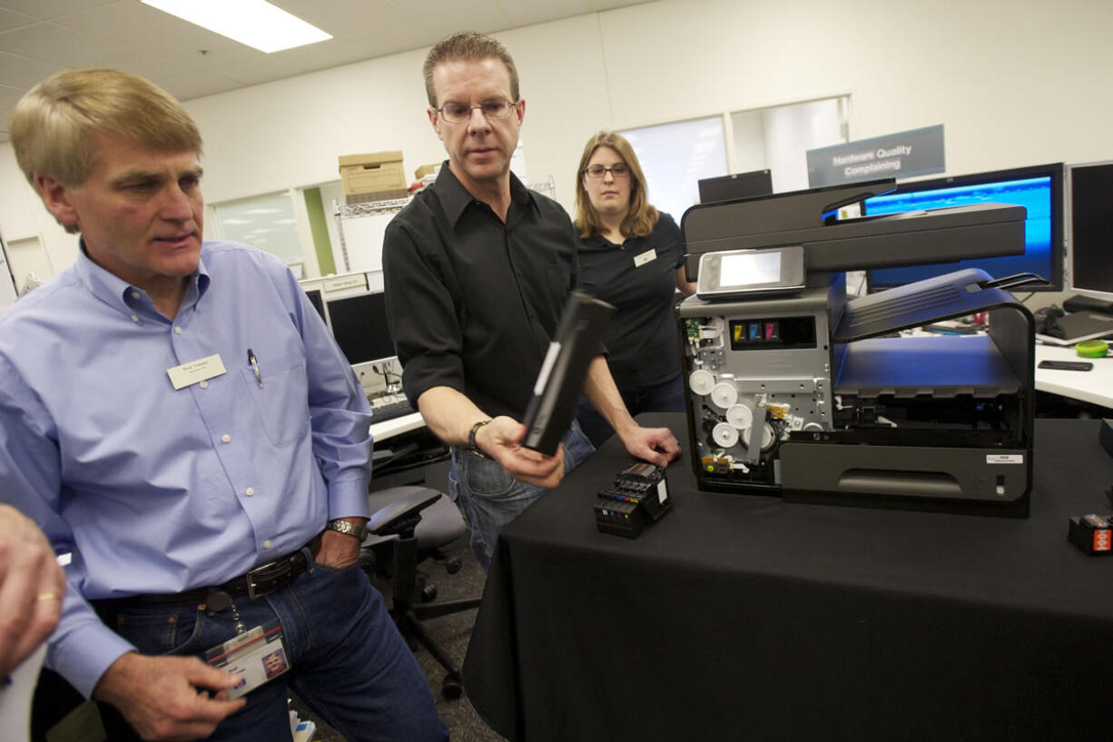 Brad Freeman, left, director of research and development in HP's Printing and Personal Systems Group, discusses the company's Officejet printer that was years in the making in Vancouver and other locations. The printer is the fastest in its class, capable of printing 70 pages a minute.