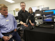 Brad Freeman, left, director of research and development in HP's Printing and Personal Systems Group, discusses the company's Officejet printer that was years in the making in Vancouver and other locations. The printer is the fastest in its class, capable of printing 70 pages a minute.