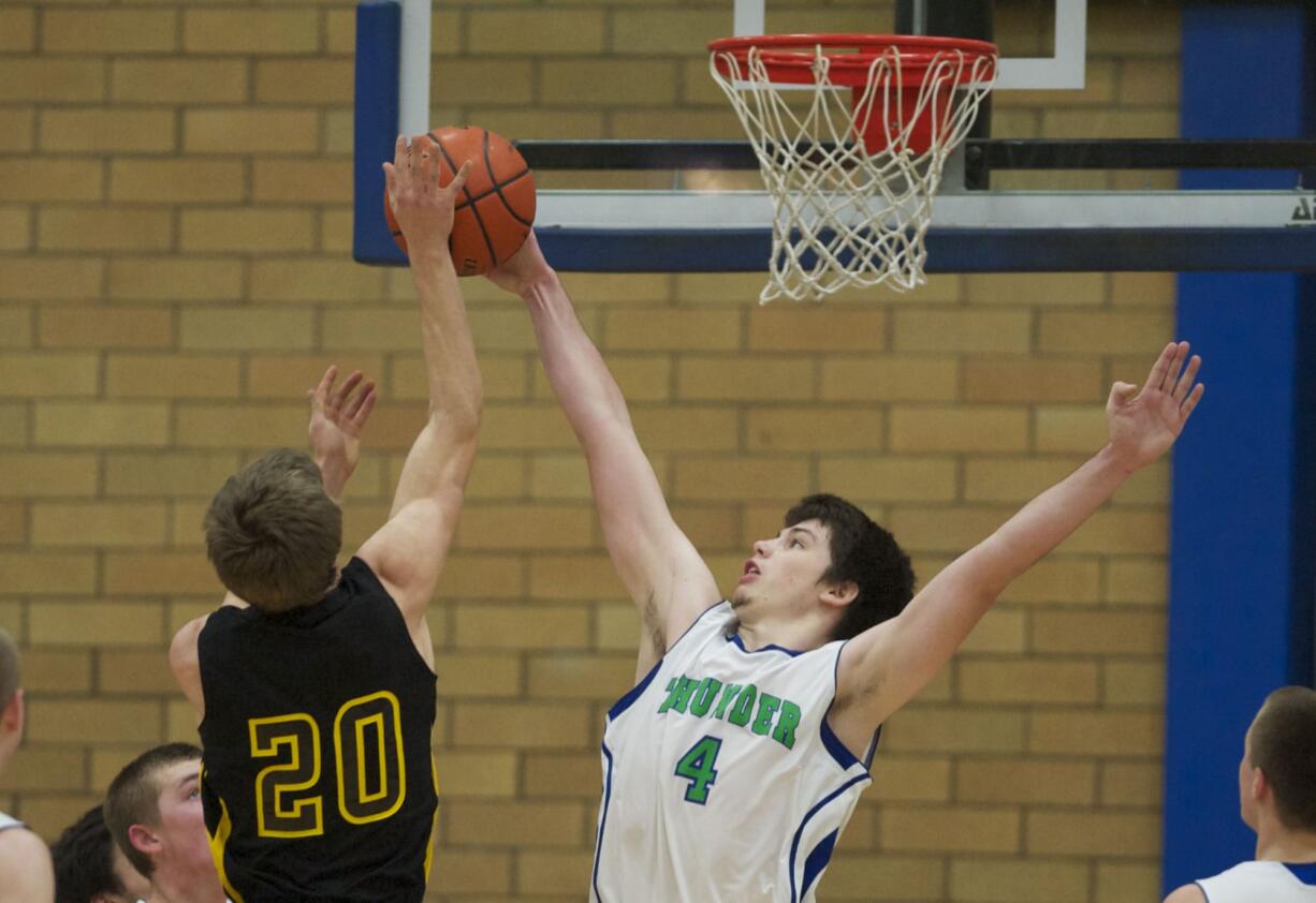 Mountain View's Shane McCauley, #4, blocks the shot of  Hudson's Bay's Jacob Buslach, Friday, January 4, 2013.