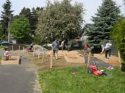 Bella Vista: Neighborhood volunteers build raised-bed  gardens in the park May 19.