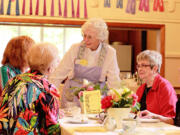 Venersborg: Volunteer Carol Jensen, standing, serves women at the Historic Venersborg Schoolhouse tea on May 26.