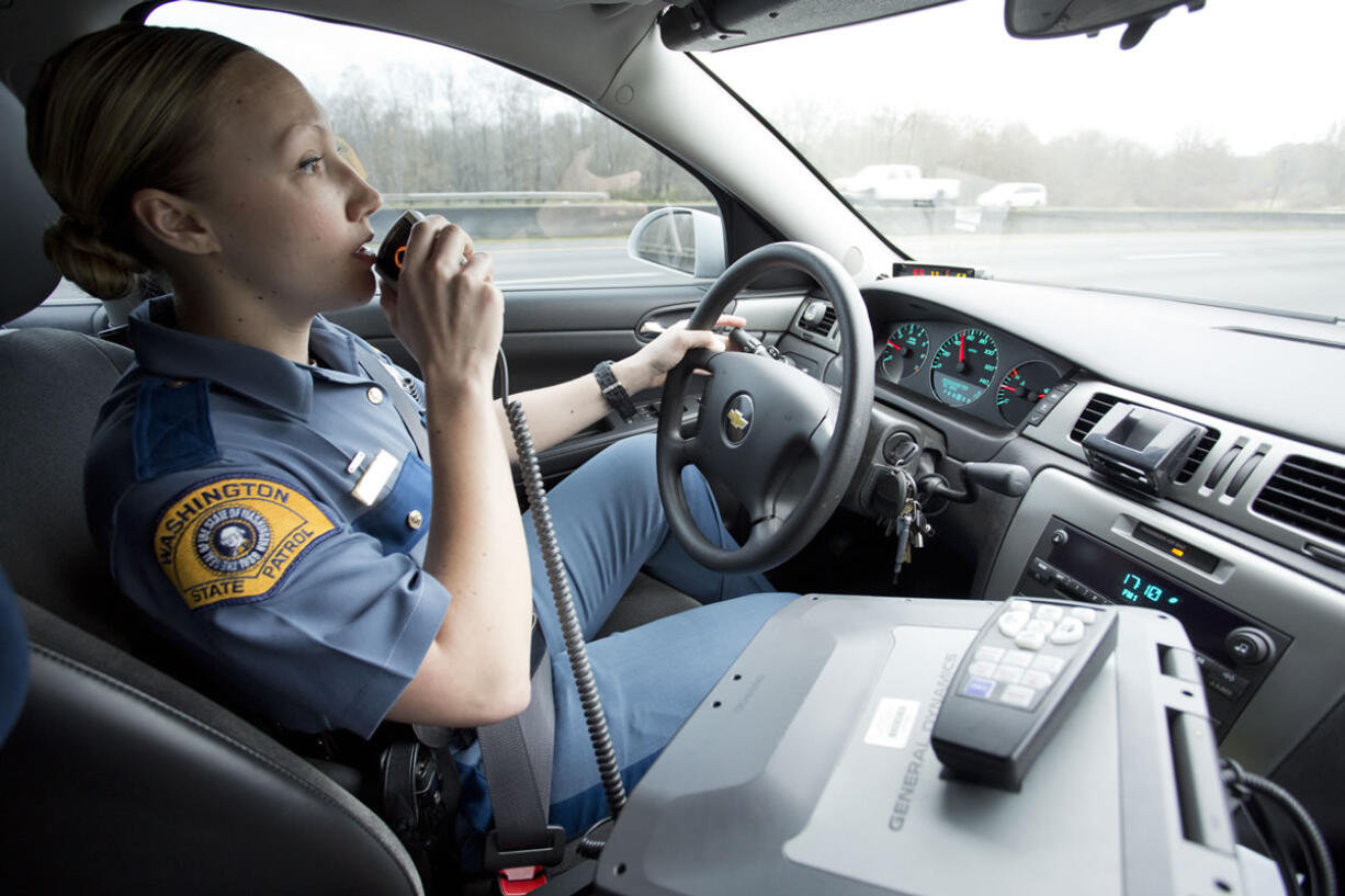 Washington State Patrol Trooper Alexis Tonissen radios dispatch about an aggressive speeder on Interstate 5.