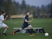 Seton Catholic's Erik Powell move the ball up field with Ridgefield's Liam Knoeppel in tow during the first half at RHS on Wednesday March 20, 2013. Ridgefield won the game 3-0.