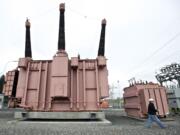 Bonneville Power Administration civil engineering technician David Robledo walks past a test transformer at Vancouver's Ross Complex substation.