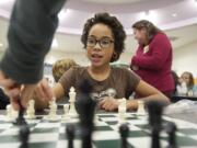 Fourth-grader Brooklyn Munoz, 10, ponders her next move while participating in an after-school chess club, one of many activities offered through Harney Elementary's family and community resource center.