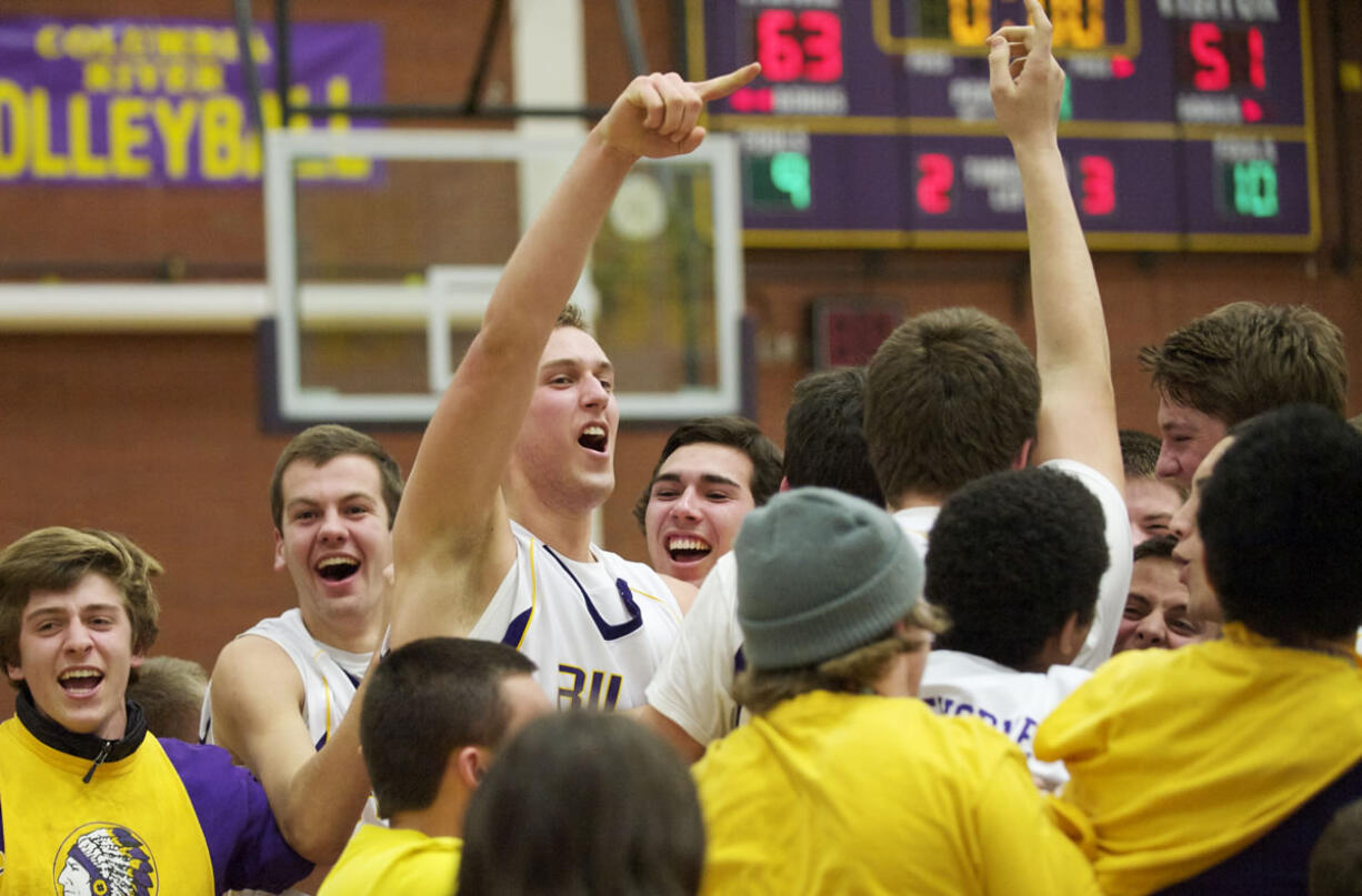 Columbia River celebrates after beating Mountain View at the 3A district basketball finals at Columbia River High School, Friday, February 8, 2013.