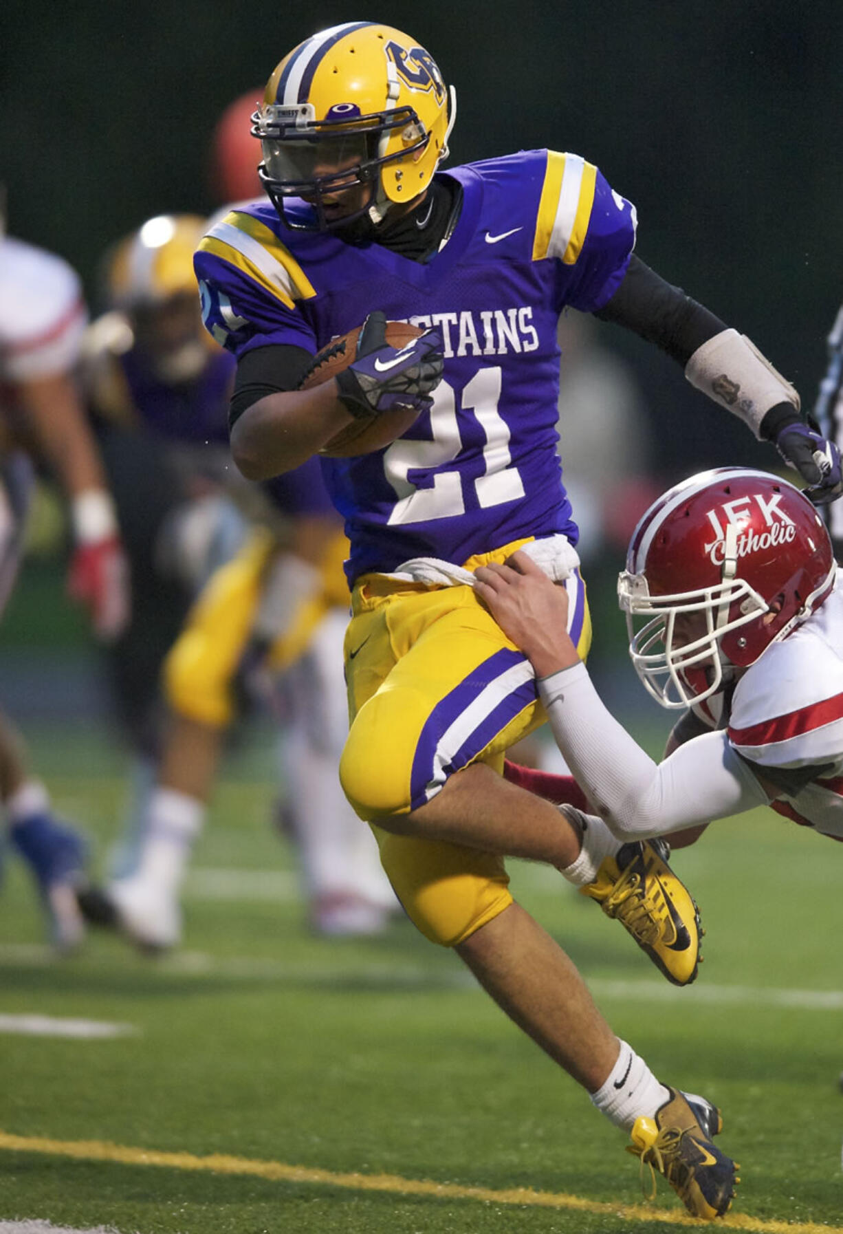 Columbian River's Jayson Branson fights his way across the goal-line to tie the game 7-7 against Kennedy Catholic in a 3A playoff match-up in the first half at Kiggins Bowl on Saturday November 10, 2012. River lost the game 14-20.