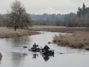 Dennis Pritchard, front, and Sam Pritchard take advantage of plentiful water Saturday to float near the Salmon Creek Greenway Trail.