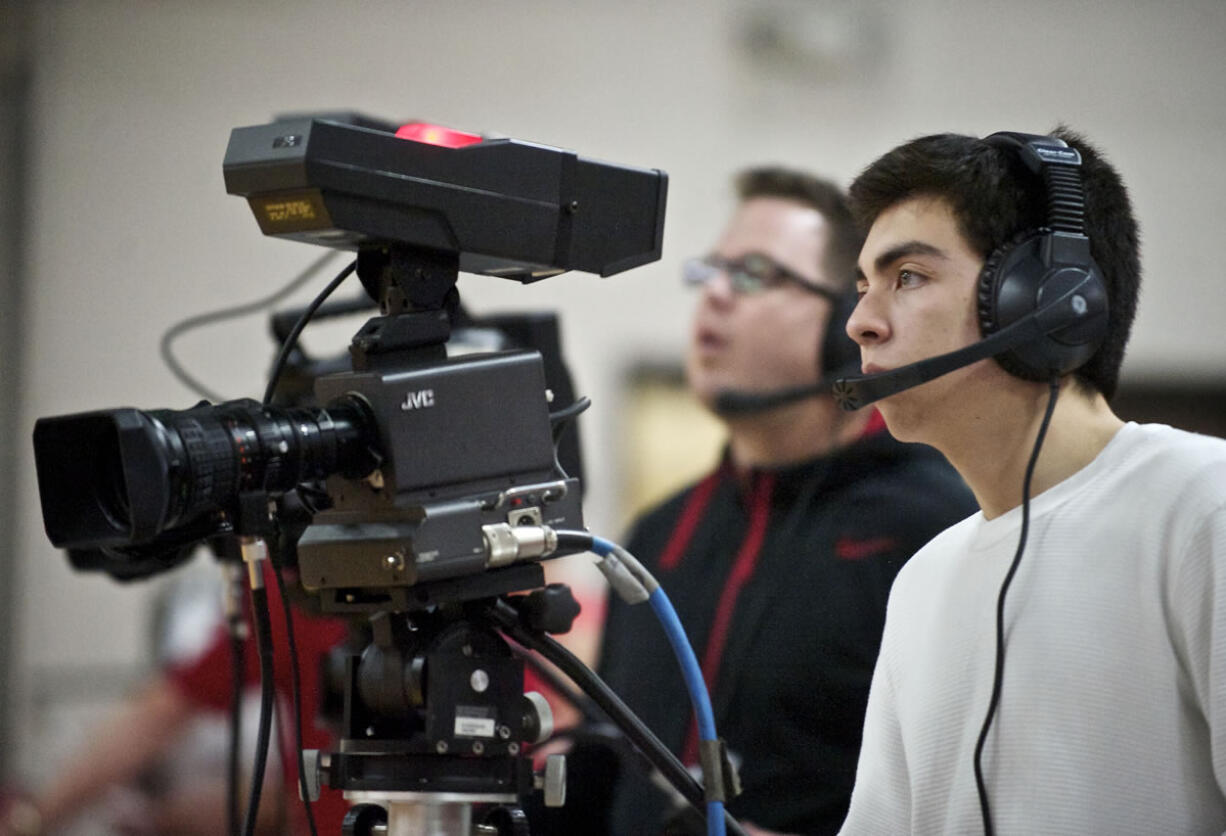 Fort Vancouver High School student Miguel Gutierrez, 16, operates a camera during a production of a girls basketball game for live television with other students inside the Fort gym on Friday January 18, 2013.