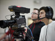 Fort Vancouver High School student Miguel Gutierrez, 16, operates a camera during a production of a girls basketball game for live television with other students inside the Fort gym on Friday January 18, 2013.