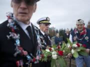 Pearl Harbor survivors Larry Lydon, from left, Ralph Laedtke and Paul Johnson prepare to cast a floral wreath into the Columbia River to commemorate the victims of the Dec.