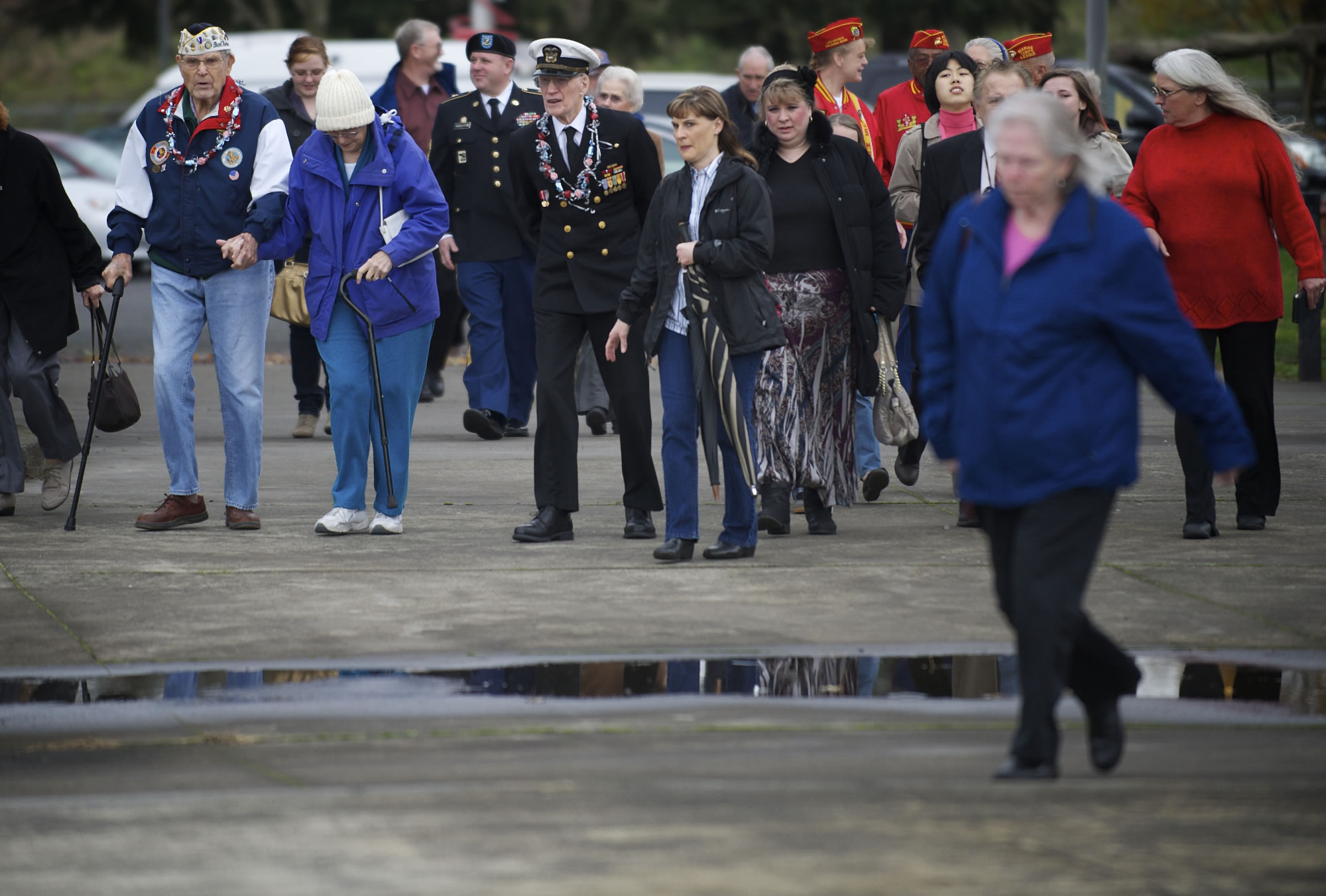 A crowd of veterans and their families walk toward the dock at the Red Lion Hotel Vancouver at the Quay to throw a wreath in the Columbia River to honor those lost in Pearl Harbor 71-years ago during a service on Friday.