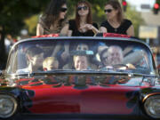 Andrew Scott, 11, from left in the front seat, Andrew Allen, 8, Garret Cochran, 12, and driver Terry Krebser -- plus some passengers Krebser didn't know -- enjoy a ride in his 1958 Chevy Impala on Saturday at the fifth annual Cruisin' the Gut along Main Street in Vancouver.