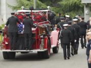 Firefighter Robert W. Hamel's casket was placed at the rear of an antique fire rig, Engine 0, and driven from downtown Vancouver to Crossroads Community Church, where his service was held.