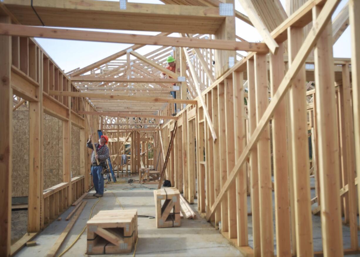 Workers recently positioned trusses on The Hampton at Salmon Creek, a 43-unit care center for seniors with memory issues.