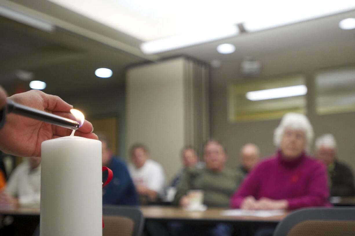 Jon Spratlen lights an &quot;AIDS Candle&quot; during a World AIDS Day event hosted by Martha's Pantry at the Clark County Health Department.