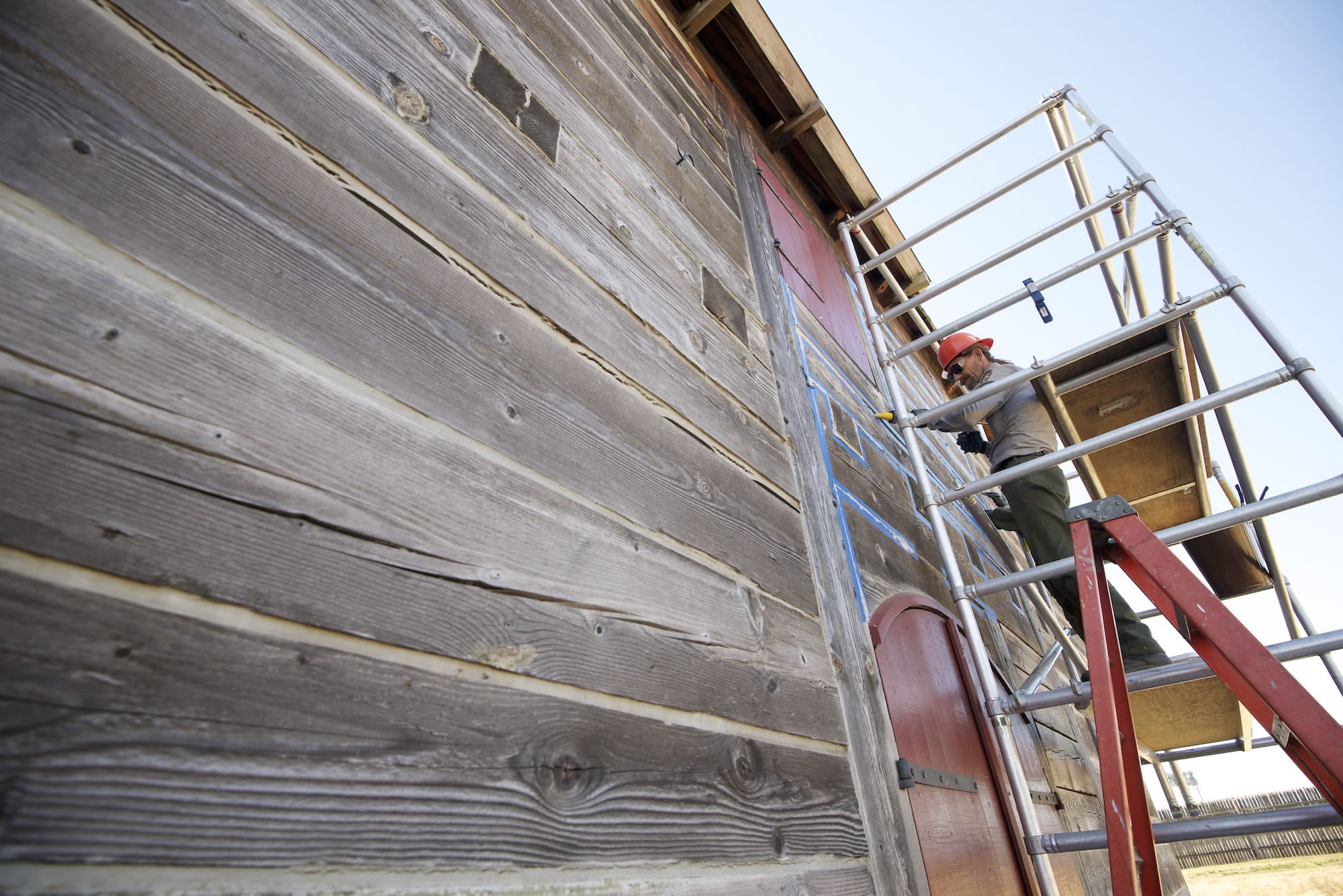 Maintenance worker Cary Porter re-chinks a gap between timbers Friday at the Fort Vancouver National Historic Site's two-story fur store, which now stores artifacts.