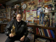 Steve Denbo in his Hazel Dell home with the trophy that he received from the NHRA Hall of Fame for the Pacific Northwest in SeaTac.