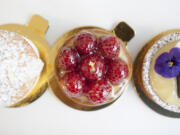 From left, a brioche with custard creme, a raspberry tart and a lemon tart are served Nov. 24 at Baron Patisserie in Vancouver.