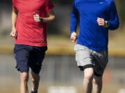 Steven Lane/The Columbian
Isaac Stinchfield, left, and Sean Eustis recently became first pair of teammates to finish the Saxon XC Invitational in Salem, Ore., in under 16 minutes.