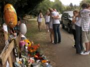 Students from Hudson's Bay High School mourn in September 2009 at a memorial set up on St.