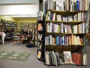 A small crowd listens to a reading at Cover to Cover Books.