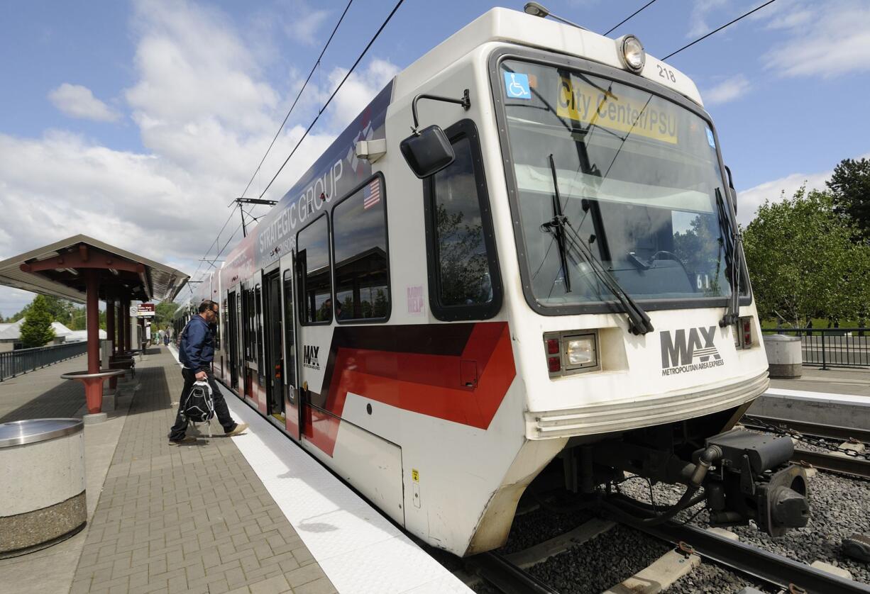 Passengers board a TriMet MAX light-rail train at the Delta Park/Vanport light-rail transit station. A Cowlitz County judge Wednesday delayed until March a decision on a lawsuit over a state law that says if a person signs a petition more than once, all their signatures must be rejected.