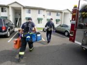 Vancouver Fire Department firefighters Pete Adams, left, and Eric Becker, from Fire Station 3 respond to a medical call near General Anderson Road.