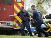 East County Fire and Rescue firefighters Capt. Wesley Long, left, and John Prasch transport a patient to a waiting ambulance.