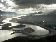 This aerial photograph of the Columbia River Gorge from 2006 shows the view looking west with Bonneville Dam in the foreground.