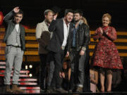 Mumford &amp; Sons, from left, Ben Lovett, Ted Dwayne, Marcus Mumford and Country Winston Marshall accept the award for album of the year for &quot;Babel&quot; at the 55th annual Grammy Awards on Sunday in Los Angeles.