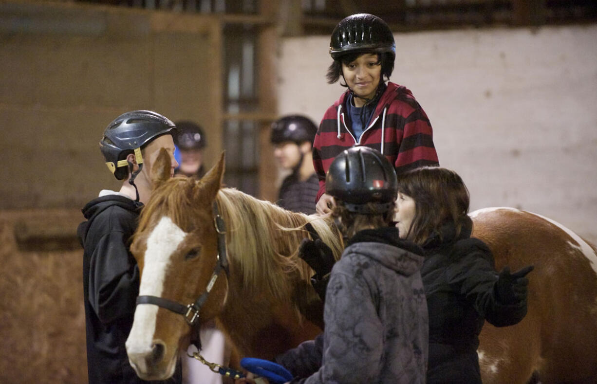 Photos by Steven Lane/The Columbian
Josh Farmer, 12, rides Cowboy for the first time at Silver Buckle Ranch. The ranch's core program is intended to build confidence through interactions with horses.