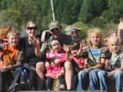 From left, Joziah Mattison, Sumer Mattison, Jake Mattison, holding Lola, then Lily, Mekhi and Kamren Mattison head to the pumpkin patch at the Pomeroy Living History Farm in Yacolt, Wa., Sunday Oct., 7 2012.