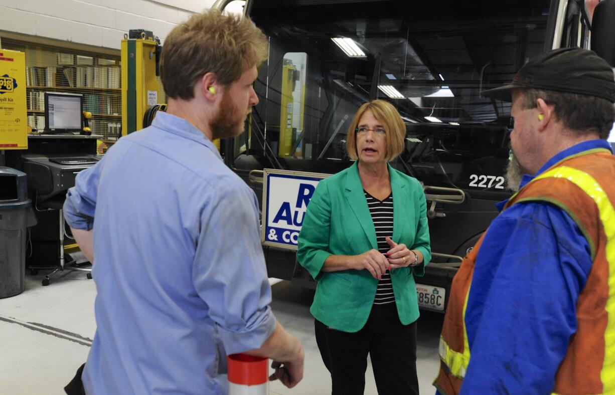 Celia Sherbeck, C-Tran's new director of maintenance, talks with Randy Denman, left, and lead mechanic Curtis McConnell at C-Tran's administrative offices in Vancouver last week.