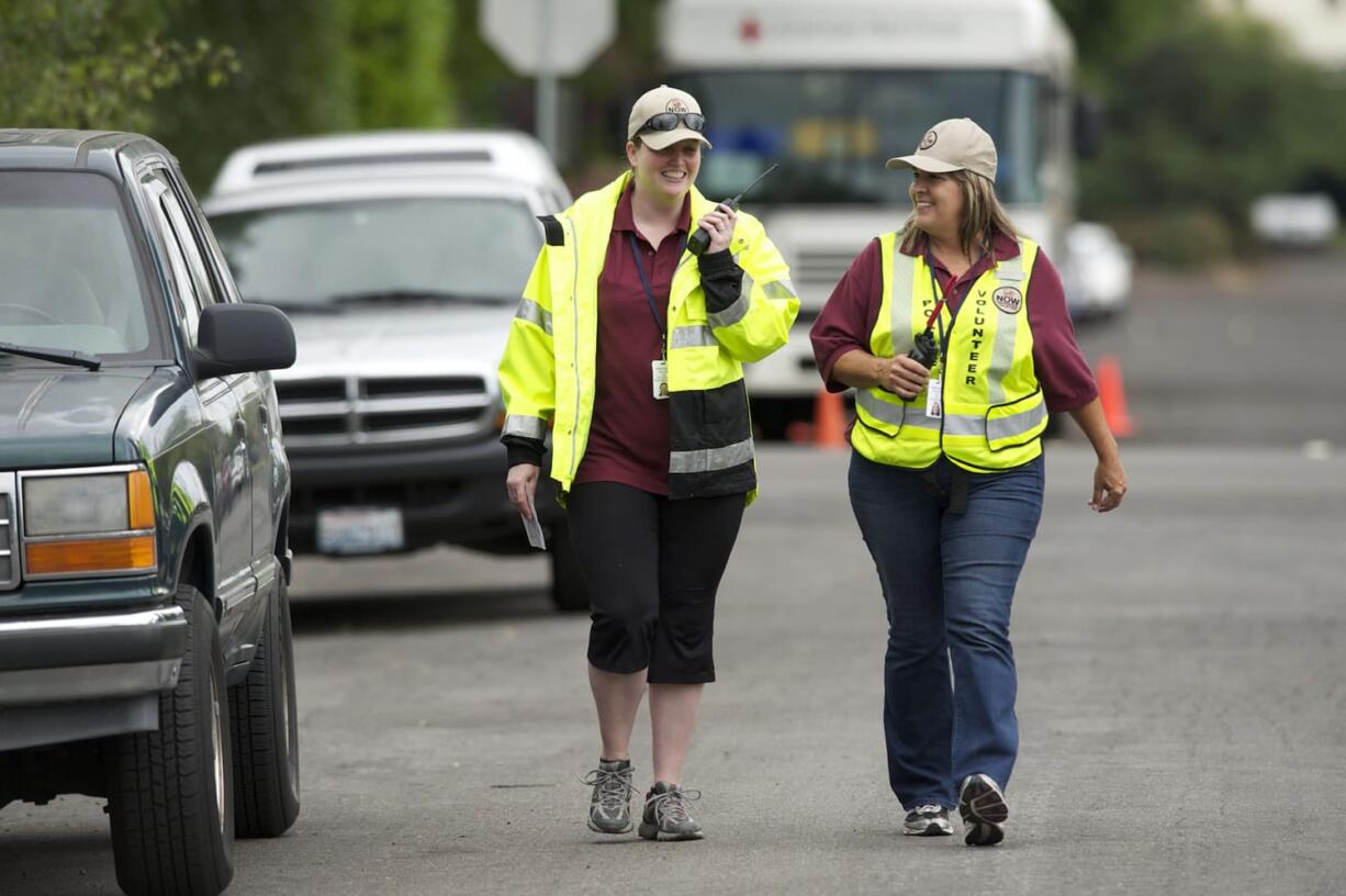 Vancouver Neighbors on Watch patrol volunteers Lia Hollander, left, and Lisa Long patrol near 39th Avenue.