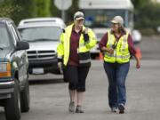 Vancouver Neighbors on Watch patrol volunteers Lia Hollander, left, and Lisa Long patrol near 39th Avenue.