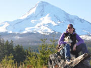 Erin Coburn of Vancouver and her dog, Stihl, pose for a photo after hiking though Mount Hood National Forest last winter to cut down a Christmas tree.