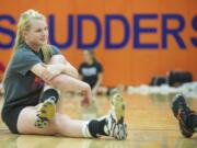 Shannon Boyle of Ridgefield High School stretches before the start of volleyball practice Monday October 14, 2013 in Ridgefield, Washington. Boyle, is a three-sport athlete at Ridgefield.