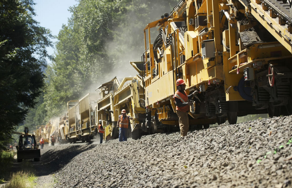 An 1,800-foot Loram &quot;undercutter&quot; machine reconditions the railroad bed under the tracks on Thursday near North Bonneville.