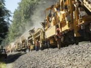 An 1,800-foot Loram &quot;undercutter&quot; machine reconditions the railroad bed under the tracks on Thursday near North Bonneville.