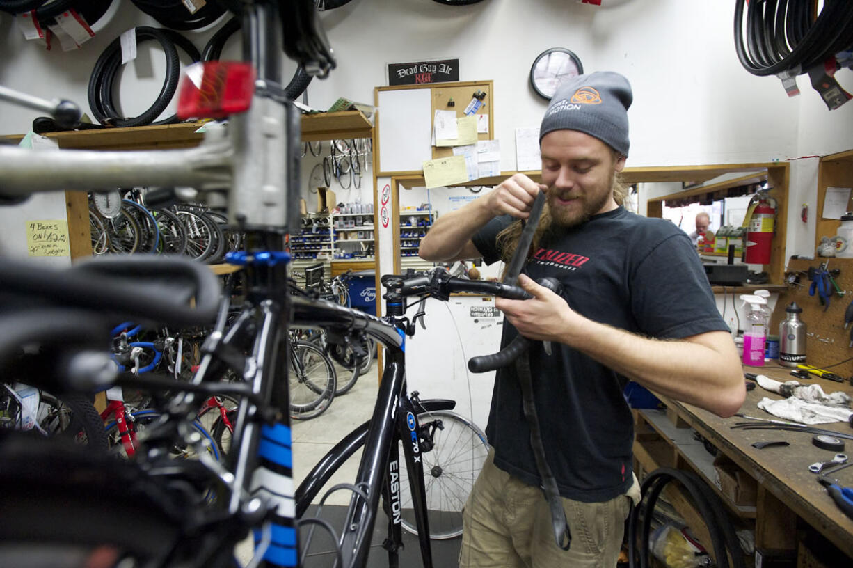 Vancouver Cyclery employee Daniel Muirhead repairs a bicycle.