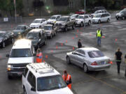 A line of vehicles forms in a parking lot laid out with traffic cones for a typical Zaycon Foods meat delivery &quot;event.&quot; Zaycon is based in Spokane and delivers beef, fish, chicken, ham and bacon to parking lots across the nation, including Clark County at the Vancouver First Friends Church, 2710 N.E.