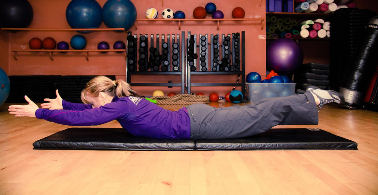 Leah Minick demonstrates the Superman with snow angel arms plus breathing exercise.