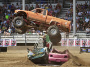 Bob Miller, 76, of Naselle jumps two cars in his converted Toyota pickup  during the Monster Truck Show at the Clark County Fair.