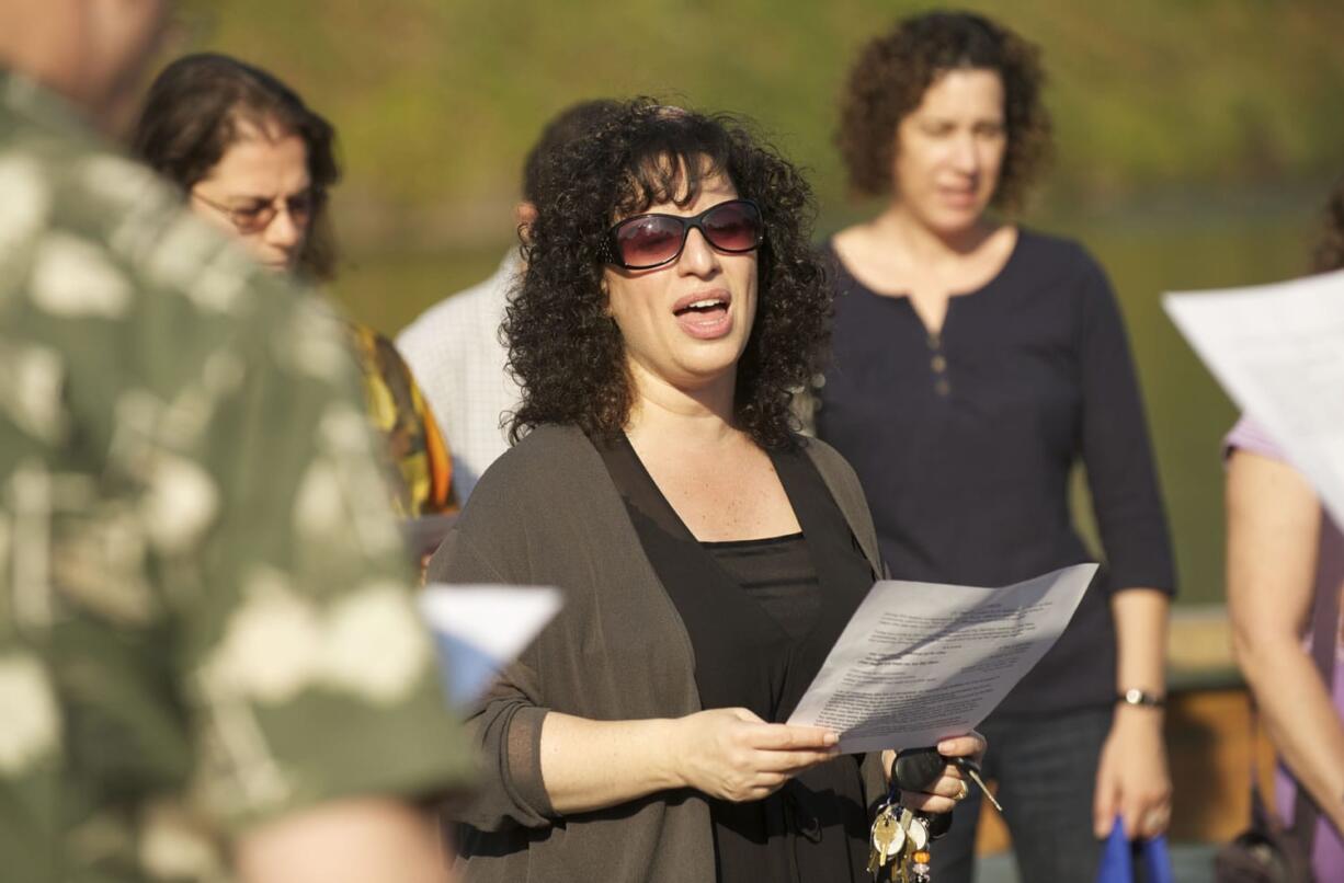 Rabbi Elizabeth Dunskerof Congregation Kol Ami leads a traditional Tashlich ceremony Monday afternoon at Klineline Pond in Salmon Creek.