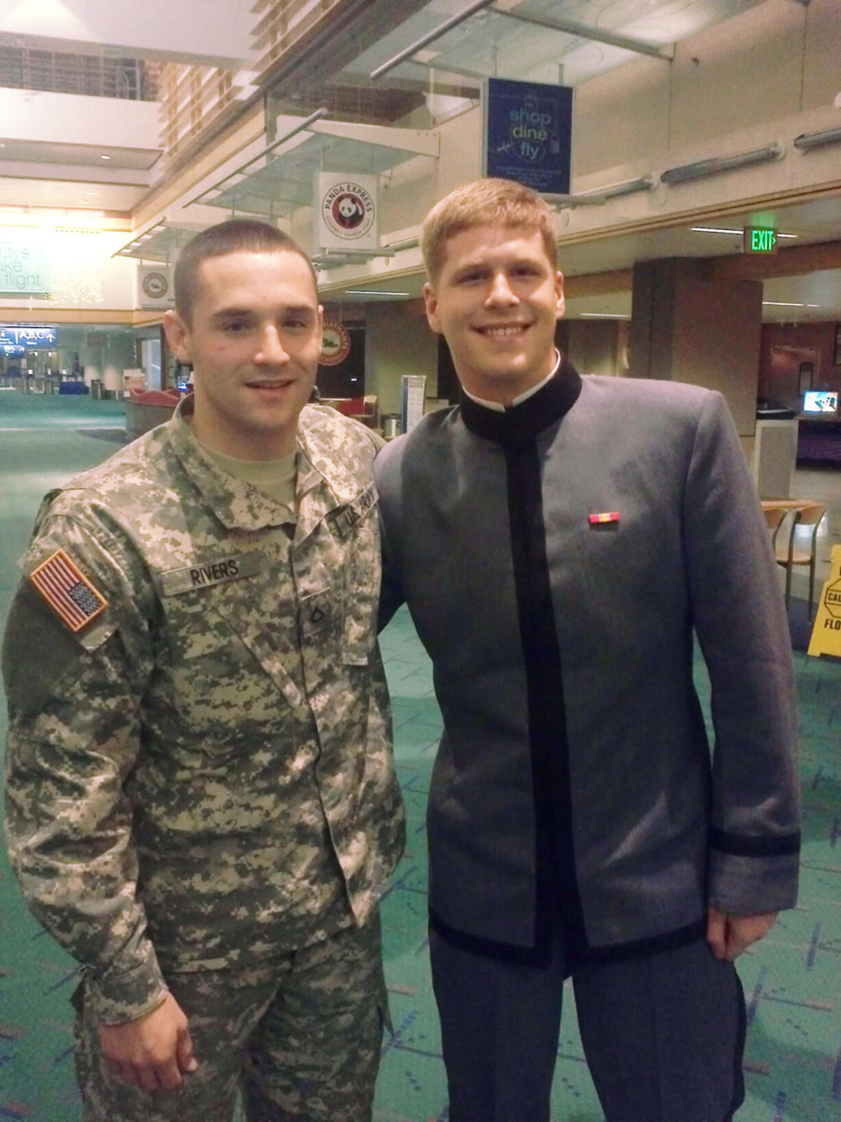 Private First Class Michael Rivers, left, and West Point cadet Zach Hall at the Portland International Airport on Wednesday.