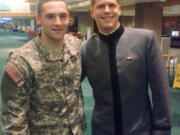 Private First Class Michael Rivers, left, and West Point cadet Zach Hall at the Portland International Airport on Wednesday.