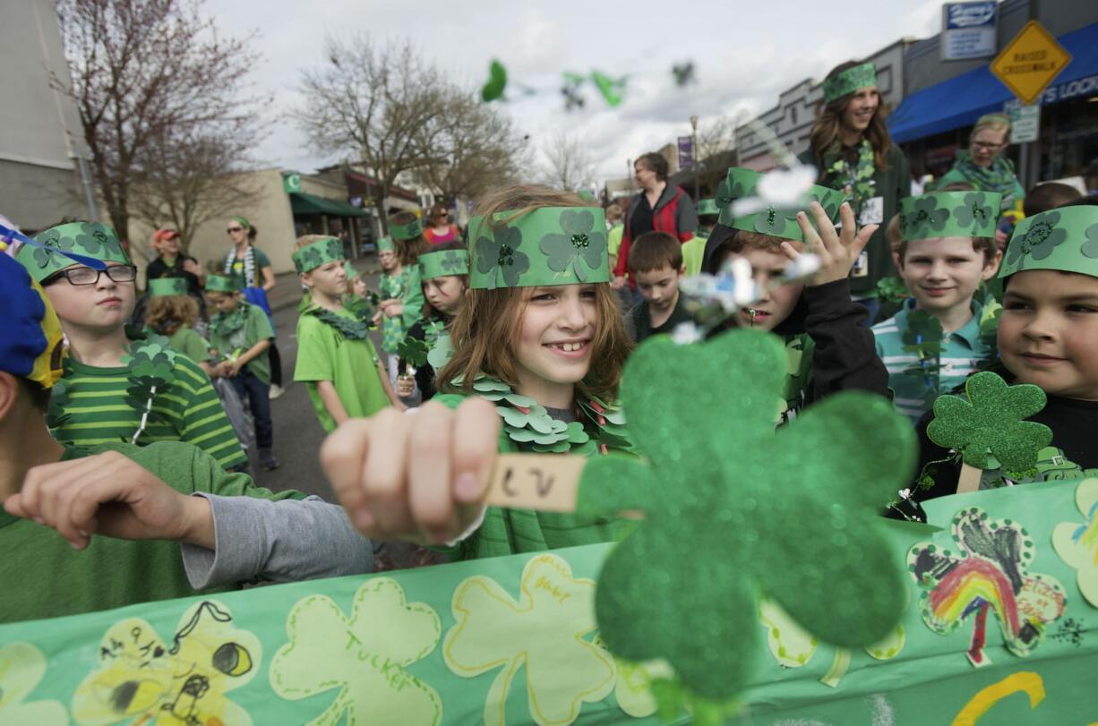 Jones Woods, 7, center, marches in the 2013 Paddy Hough Parade Friday with his second grade class.